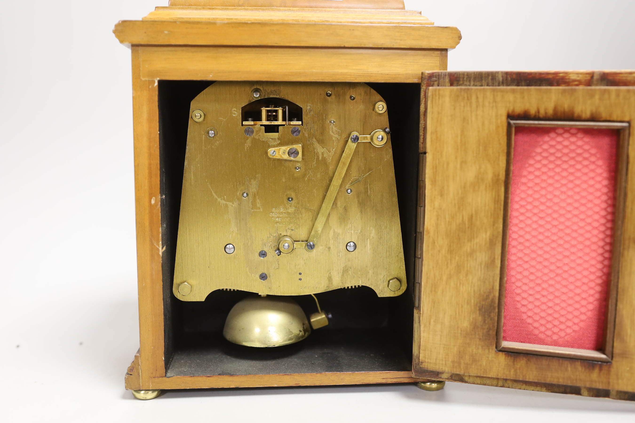 A figured walnut mantel clock by Elliott